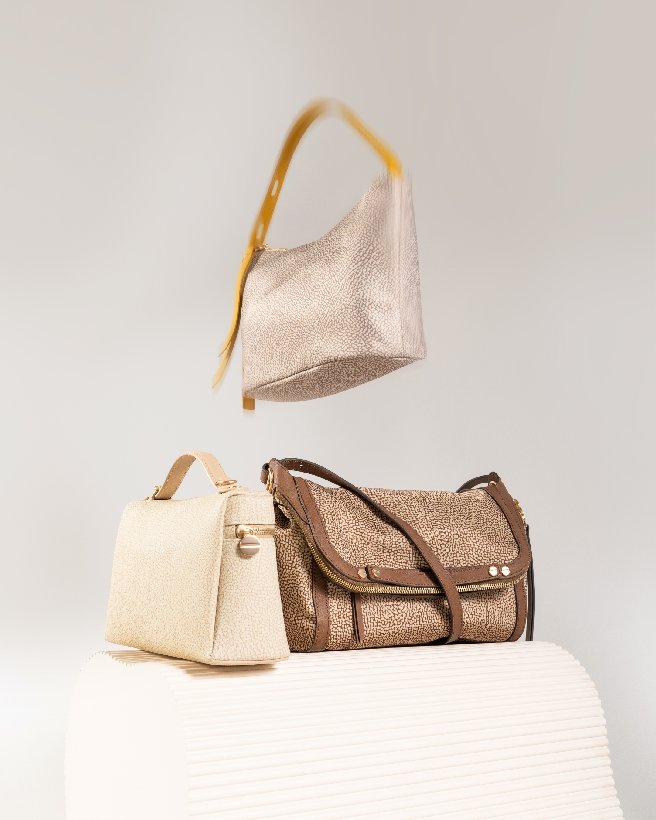 Brand italiano di lusso, celebre per le borse con motivo "Occhio di Pernice".